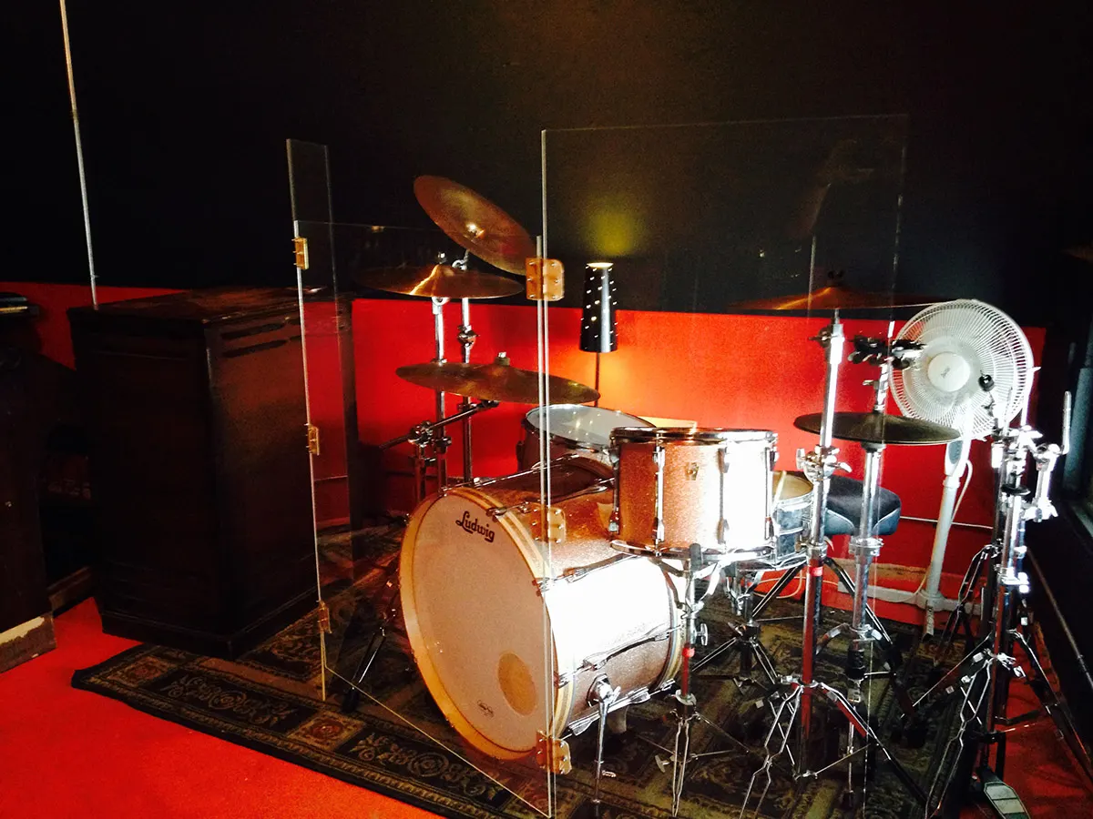 Marsonic hourly rehearsal room with drum kit, shields, red walls, and space to test a set