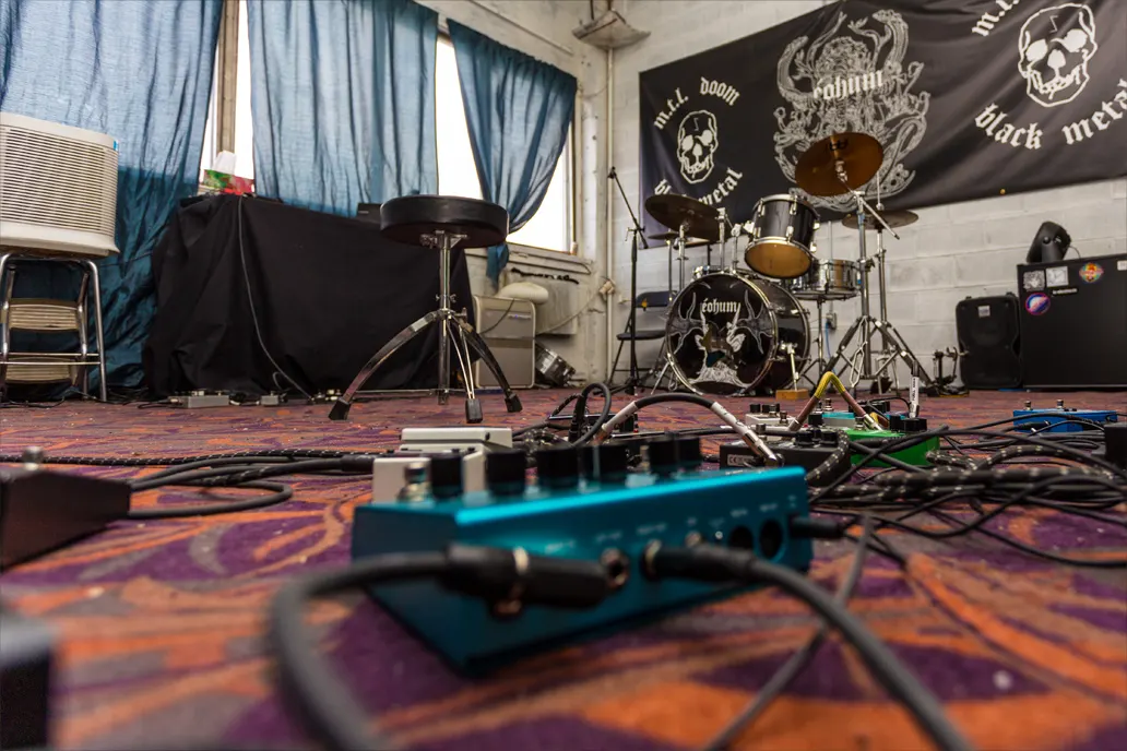 Marsonic rehearsal room with drums, pedals, cables, and space to test a set before a November showcase push